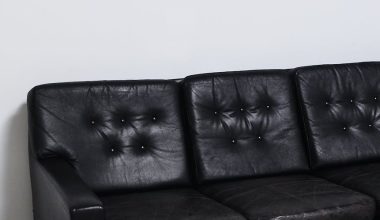 weathered black leather sofa in light room